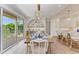 Dining room with an elegant chandelier, bar area, and sliding glass doors to the balcony at 215 83Rd St, Holmes Beach, FL 34217