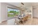 Elegant dining area filled with natural light; features modern chandelier and seamlessly blends with the outdoors at 215 83Rd St, Holmes Beach, FL 34217