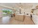 Elegant kitchen with an island, white cabinets, modern appliances, and seamlessly connects to the dining area at 215 83Rd St, Holmes Beach, FL 34217