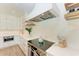 Modern kitchen features stainless steel appliances, quartz countertops, and open shelving, providing both style and function at 215 83Rd St, Holmes Beach, FL 34217
