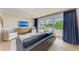 Comfortable living room with a large leather sofa, flat screen TV, and sliding glass doors that provide ample natural light at 215 83Rd St, Holmes Beach, FL 34217