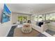 Bright living room with a view to the pool, comfortable seating, and a flat screen TV for entertainment at 215 83Rd St, Holmes Beach, FL 34217