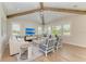 Bright living room features high ceilings, wood beams, and abundant natural light and cozy decor at 215 83Rd St, Holmes Beach, FL 34217