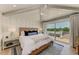 Cozy bedroom with a comfortable bed, vaulted ceilings, and sliding glass doors to the outside deck at 215 83Rd St, Holmes Beach, FL 34217