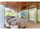 Outdoor space featuring a comfortable seating area with a TV, stone fireplace and vaulted wood ceilings at 215 83Rd St, Holmes Beach, FL 34217