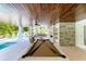 Great outdoor living area with vaulted ceilings, fireplace, outdoor dining and pool table for entertainment at 215 83Rd St, Holmes Beach, FL 34217