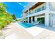 Stunning backyard featuring a sparkling pool, stylish lounge chairs, and lush tropical landscaping perfect for outdoor living at 215 83Rd St, Holmes Beach, FL 34217