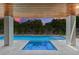 Inviting in-ground pool, spa, and verdant landscaping offer a serene outdoor retreat with ambient sunset views at 215 83Rd St, Holmes Beach, FL 34217