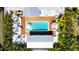 Aerial view of a backyard oasis with a sparkling pool, wooden deck, and tropical landscaping at 2308 Tulip St, Sarasota, FL 34239