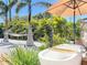 Outdoor soaking tub surrounded by lush greenery, a hammock, a lounge chair, and a shady umbrella at 2308 Tulip St, Sarasota, FL 34239