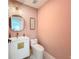 Stylish half bathroom with a vanity, modern fixtures, and pink walls at 2308 Tulip St, Sarasota, FL 34239