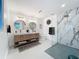 Bright bathroom with a double sink vanity and a walk-in shower featuring marble tile surround at 2308 Tulip St, Sarasota, FL 34239