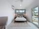 Bedroom with a statement wall, sliding glass doors to the outside, and a ceiling fan at 2308 Tulip St, Sarasota, FL 34239