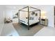 Spacious bedroom featuring a four-poster bed, area rug, and stylish decor at 2308 Tulip St, Sarasota, FL 34239