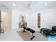 Bonus room with natural light, showcasing a workout bench, ceiling fan, and storage cabinets at 2308 Tulip St, Sarasota, FL 34239