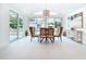 Bright dining room with a chandelier, pool views, and seating for six at 2308 Tulip St, Sarasota, FL 34239