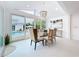 Bright dining room with modern chandelier, glass table, and views of the pool at 2308 Tulip St, Sarasota, FL 34239