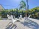 Outdoor fire pit surrounded by white gravel and Adirondack chairs at 2308 Tulip St, Sarasota, FL 34239