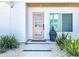 Stylish front door with glass panels, stepping stone pathway, and garden at 2308 Tulip St, Sarasota, FL 34239