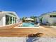 Stunning pool between two buildings with wooden deck and lounge seating at 2308 Tulip St, Sarasota, FL 34239