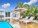 Beautiful outdoor area with a pristine pool, wooden deck, and comfortable lounge chairs at 2308 Tulip St, Sarasota, FL 34239