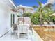 Outdoor dining and lounge area by the pool with tropical landscaping at 2308 Tulip St, Sarasota, FL 34239