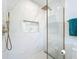 Shower featuring marble tile surround, gold fixtures including shower head and handheld wand, and a built-in niche at 2308 Tulip St, Sarasota, FL 34239