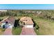 Aerial view of a home with a clay tile roof, brick driveway, and lush landscaping at 2322 5Th E St, Palmetto, FL 34221