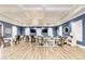 Large common room featuring multiple seating areas, tables, wood-look tile flooring, and recessed lighting at 2322 5Th E St, Palmetto, FL 34221