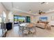 A dining room has a large round table and chairs with a sliding glass door at 2322 5Th E St, Palmetto, FL 34221