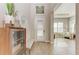 Bright foyer with light wood floors, a storage cabinet, and a view into the living area at 2322 5Th E St, Palmetto, FL 34221