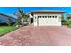 Beautiful single-story home with a brick driveway, well-kept lawn, and a beige exterior color at 2322 5Th E St, Palmetto, FL 34221