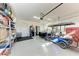 Spacious garage with epoxy flooring, storage shelves, beverage fridge, and a golf cart at 2322 5Th E St, Palmetto, FL 34221