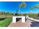 Outdoor brick grill station with countertop, brick storage, and view of the backyard landscaping under a sunny sky at 2322 5Th E St, Palmetto, FL 34221
