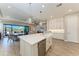 Open kitchen with island, stainless steel appliances and adjacent outdoor living area at 2322 5Th E St, Palmetto, FL 34221