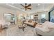 Open concept living room with modern decor, a large rug, and a view of the kitchen at 2322 5Th E St, Palmetto, FL 34221