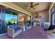 Covered outdoor kitchen featuring stainless steel grill, wine cooler, and ample seating on a brick-paved patio at 2322 5Th E St, Palmetto, FL 34221