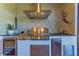 Close-up of outdoor kitchen with stainless steel grill, wine cooler, and decorative backsplash at 2322 5Th E St, Palmetto, FL 34221