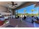 Outdoor kitchen featuring stainless steel grill, wine cooler, pizza oven, and ample seating on a brick-paved patio at 2322 5Th E St, Palmetto, FL 34221
