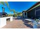 Expansive brick patio with pizza oven, seating area, and tropical landscaping for outdoor relaxation at 2322 5Th E St, Palmetto, FL 34221