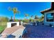 Spacious brick patio featuring a pizza oven, lounge chairs, and lush landscaping for outdoor enjoyment at 2322 5Th E St, Palmetto, FL 34221
