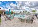 Beautiful community pool with plenty of seating, umbrellas, and a view of the water and the sky at 2322 5Th E St, Palmetto, FL 34221