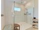 Walk-in shower featuring a frameless glass enclosure, a rain shower head, and built in shelving at 2322 5Th E St, Palmetto, FL 34221