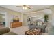 Living room with TV and open view into the kitchen with breakfast bar at 2476 Breakwater Cir, Sarasota, FL 34231