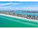Stunning aerial view of a beautiful beach, Tampa Bay ocean, and waterfront properties on a clear, sunny day at 256 144Th Ave, Madeira Beach, FL 33708