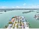 Beautiful aerial view of waterfront homes, canals, and the Tampa Bay ocean on a bright sunny day at 256 144Th Ave, Madeira Beach, FL 33708