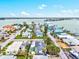Aerial view of the turquoise home nestled on a waterfront community with a bay view at 256 144Th Ave, Madeira Beach, FL 33708