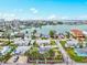 Scenic aerial view of a coastal neighborhood with waterfront homes, a vibrant cityscape, and blue waterways at 256 144Th Ave, Madeira Beach, FL 33708