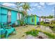 Backyard featuring a small building with a unique swirl design on the door surrounded by tropical landscaping at 256 144Th Ave, Madeira Beach, FL 33708