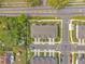 Aerial view showcasing symmetrical townhomes with neatly manicured lawns and convenient parking at 2718 Chestnut Creek Pl, Brandon, FL 33510